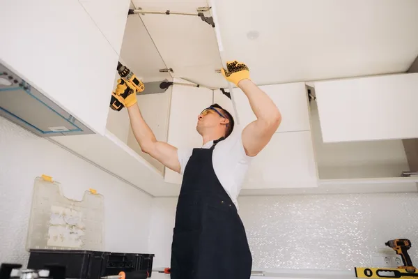 Professional Wudiqa team installing modular kitchen at client site